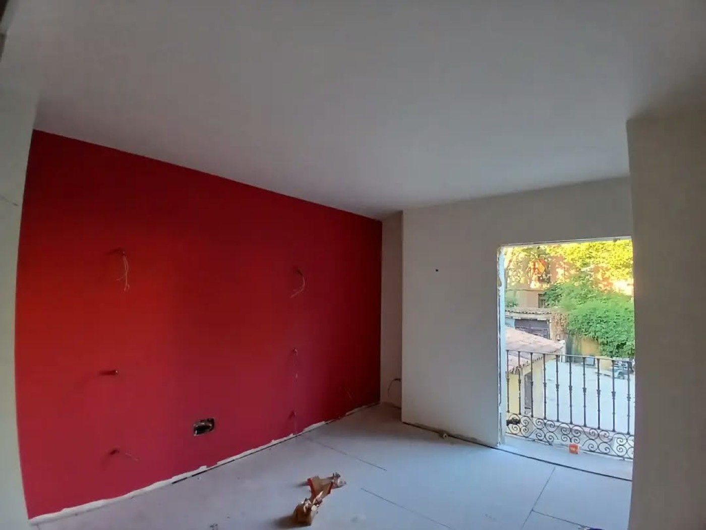 Salón reformado con pared de color y salida a balcón